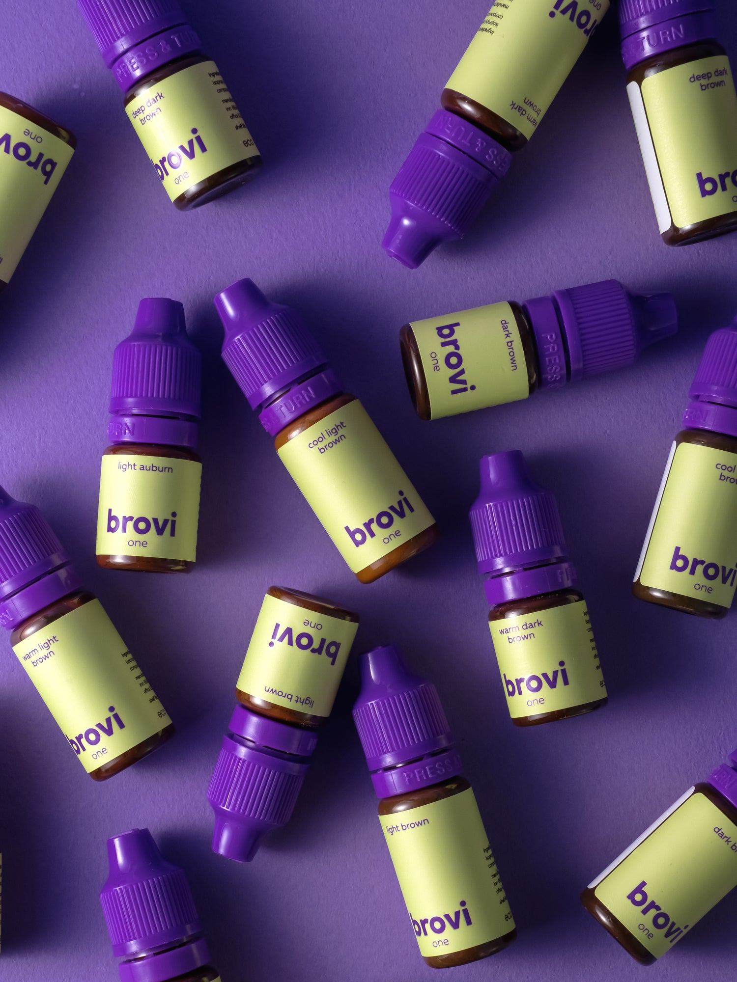 Multiple brovi one bottles with purple caps on a purple background